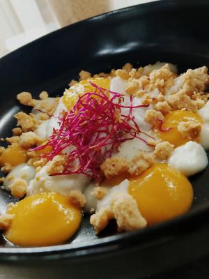 Egg cooked at low temperature with carrot, ginger and lime cream, savory crumble and parmesan fronded